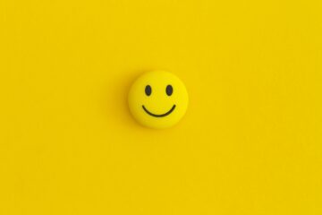 Emoticon smile on a yellow background