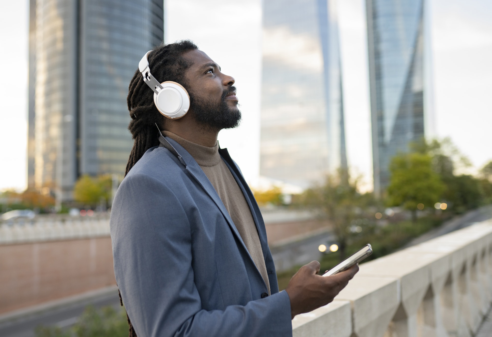 business man listening to music in the city